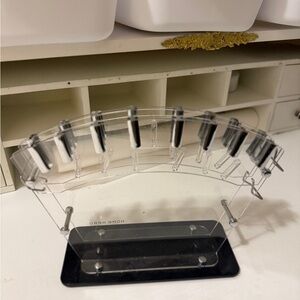 clear acrylic knife block or stand, designed to hold and display kitchen knives.